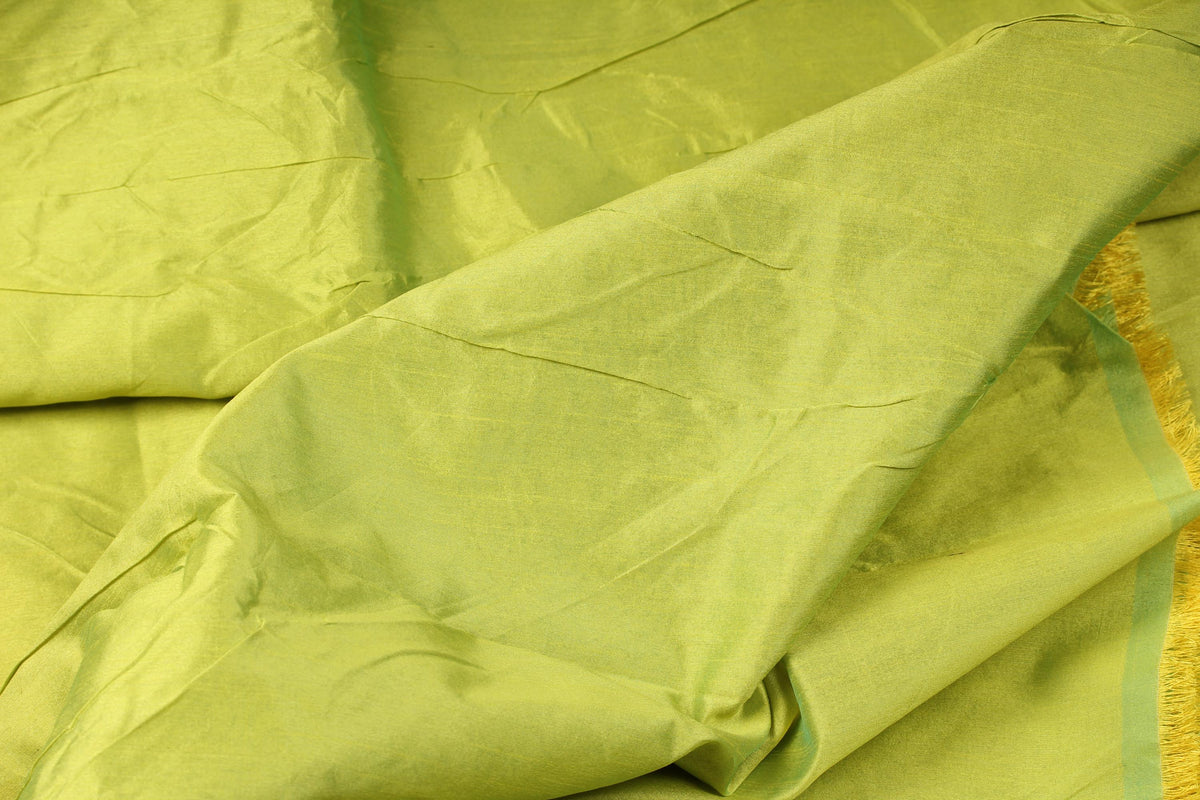 Close-up of chartreuse faux silk dupioni fabric showing its textured surface and yellow-green colour