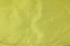 Folded chartreuse faux silk dupioni fabric in a vibrant lime yellow-green colour
