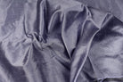 Draped smoky lavender faux dupioni fabric showing its soft folds, subtle sheen and lavender-grey colour.