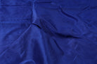 Deep blue Midnight Sapphire faux dupioni fabric arranged in soft folds, showing its rich colour and gentle sheen.