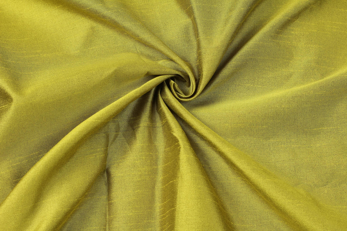 Close-up of golden olive faux silk fabric gathered into folds, highlighting its texture and drape.