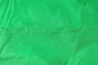 Bright parrot green faux silk fabric draped in soft flowing folds