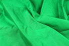 Parrot green faux silk fabric showing smooth texture and vibrant tropical green colour