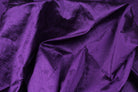 Close-up of royal amethyst faux silk fabric arranged to show its lustrous texture