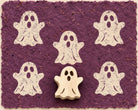 Hand carved Haunting Ghost wooden printing block with five ghost impressions on purple handmade paper.