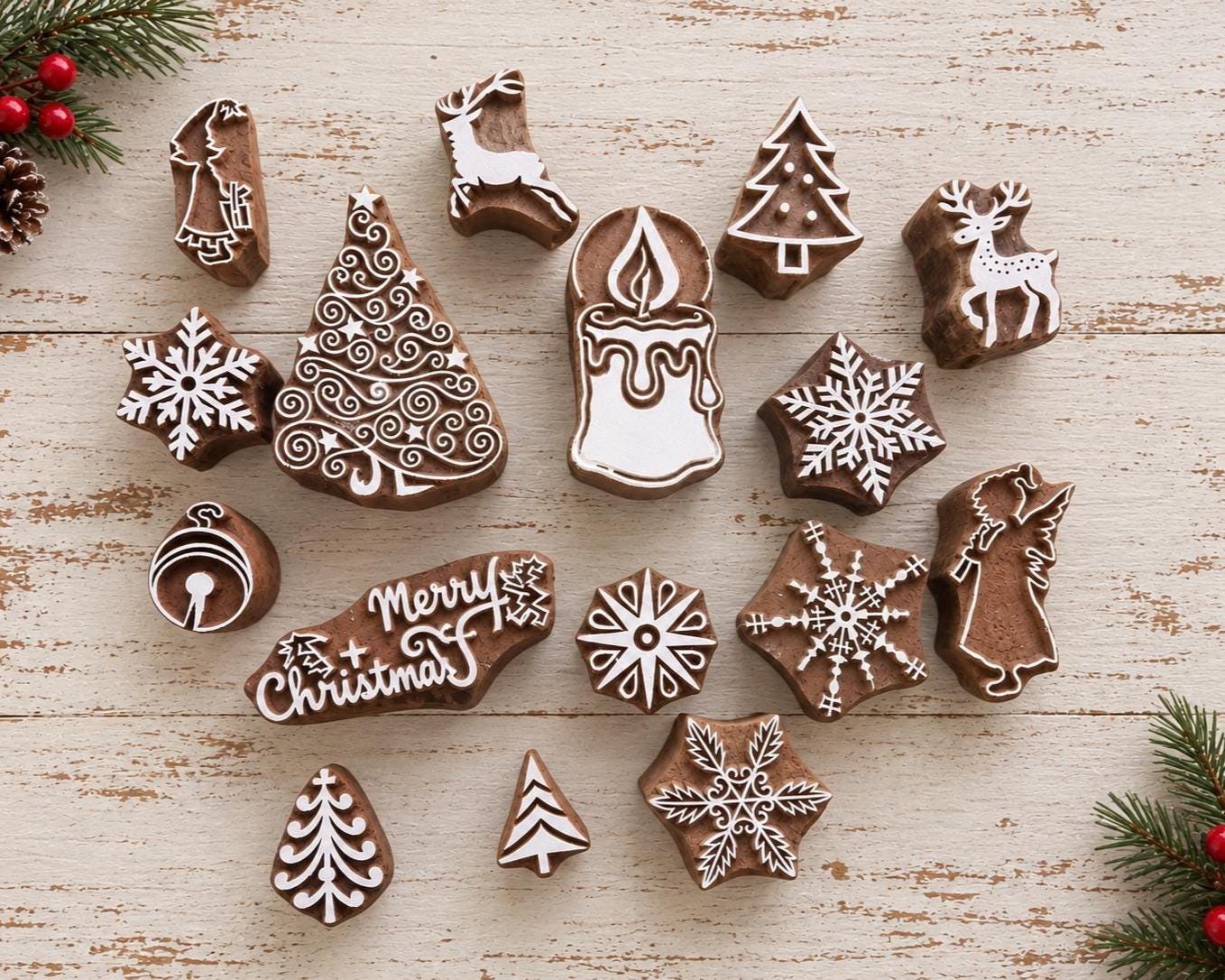 Set of 16 wooden Christmas printing blocks featuring trees, snowflakes, reindeer, candle, bell, angel and holiday motifs.