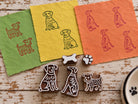 Set of five hand-carved wooden dog printing blocks including three dog designs, a bone and a paw print