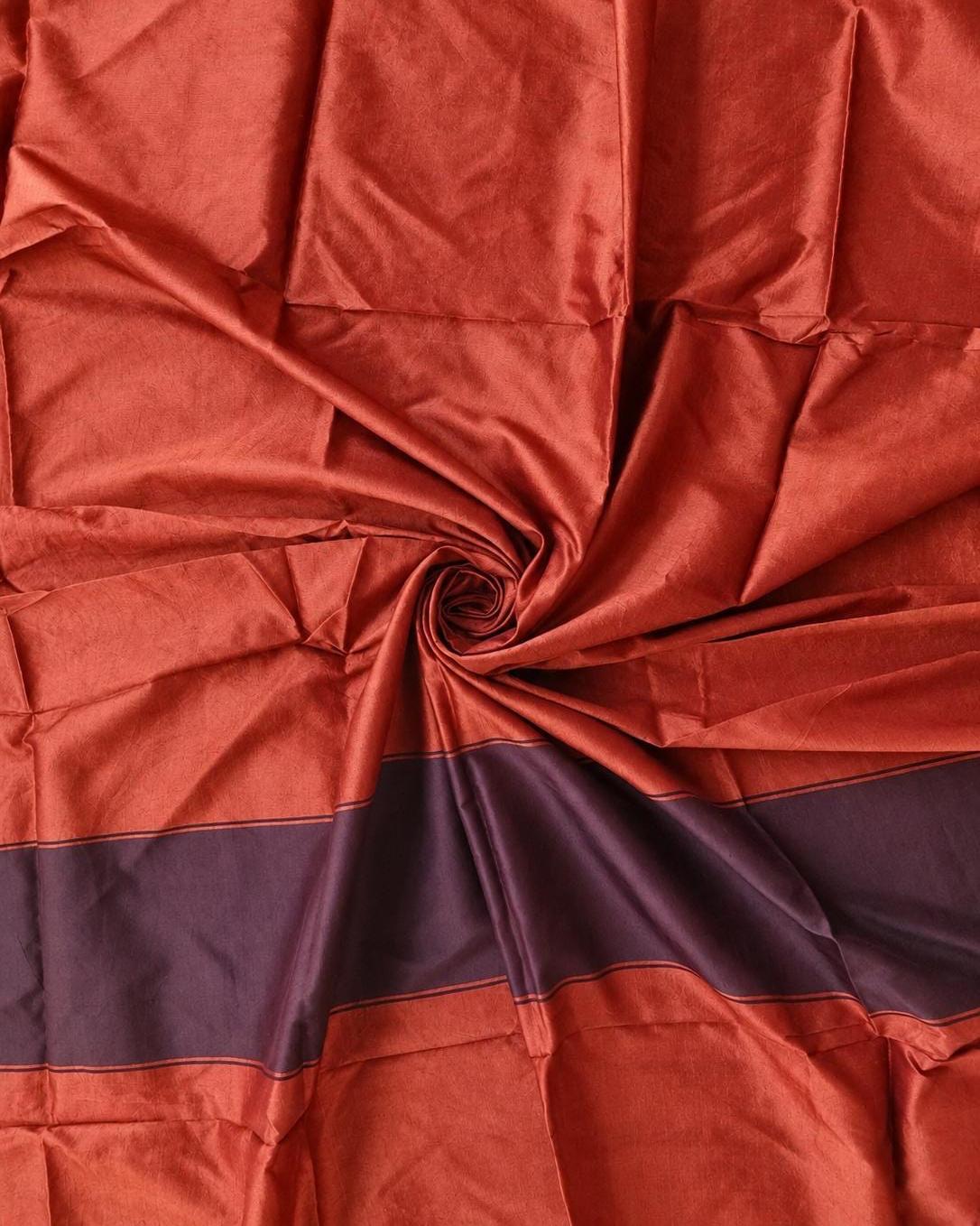 burnt orange vintage sari silk fabric draped to show soft sheen and woven texture