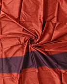 burnt orange vintage sari silk fabric draped to show soft sheen and woven texture