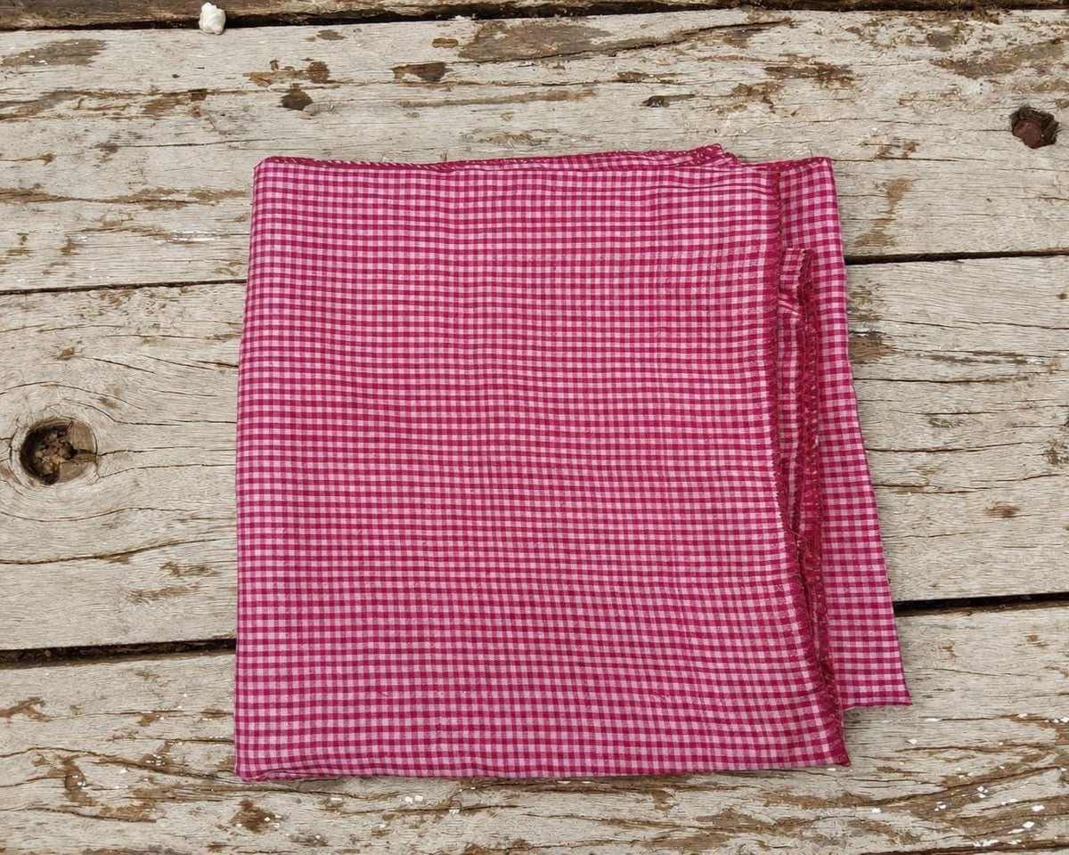Close-up of the fine pink and white checked weave on vintage pure silk saree fabric