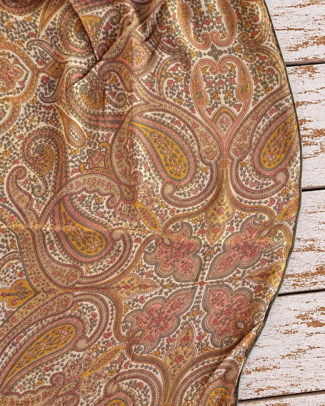 Close-up of intricate paisley and floral motifs printed on lightweight vintage silk chiffon