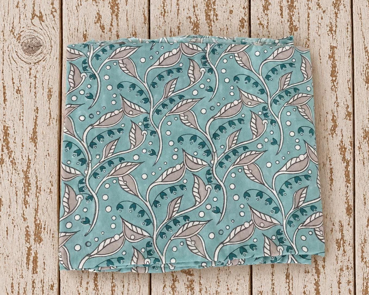 Hand block printed mulmul cotton fabric in aqua blue with Indian trailing leaf pattern