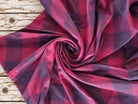 Draped vintage silk sari textile showing the oversized raspberry and plum check pattern and soft sheen