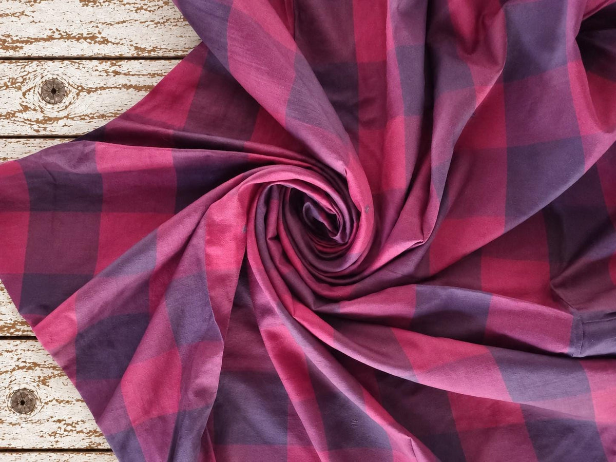Draped vintage silk sari textile showing the oversized raspberry and plum check pattern and soft sheen