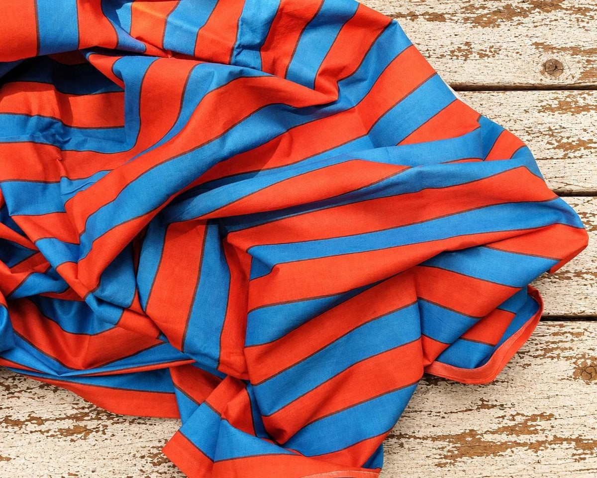 Red and blue striped lightweight cotton fabric, hand screen printed in India