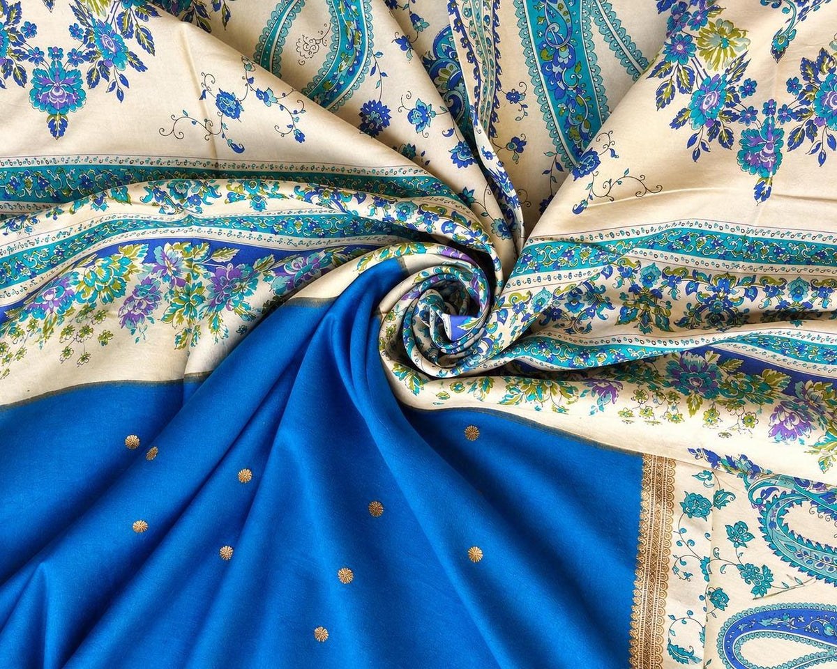 Royal blue silk with gold-toned dots arranged beside an ivory floral and paisley section.