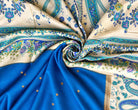 Royal blue silk with gold-toned dots arranged beside an ivory floral and paisley section.