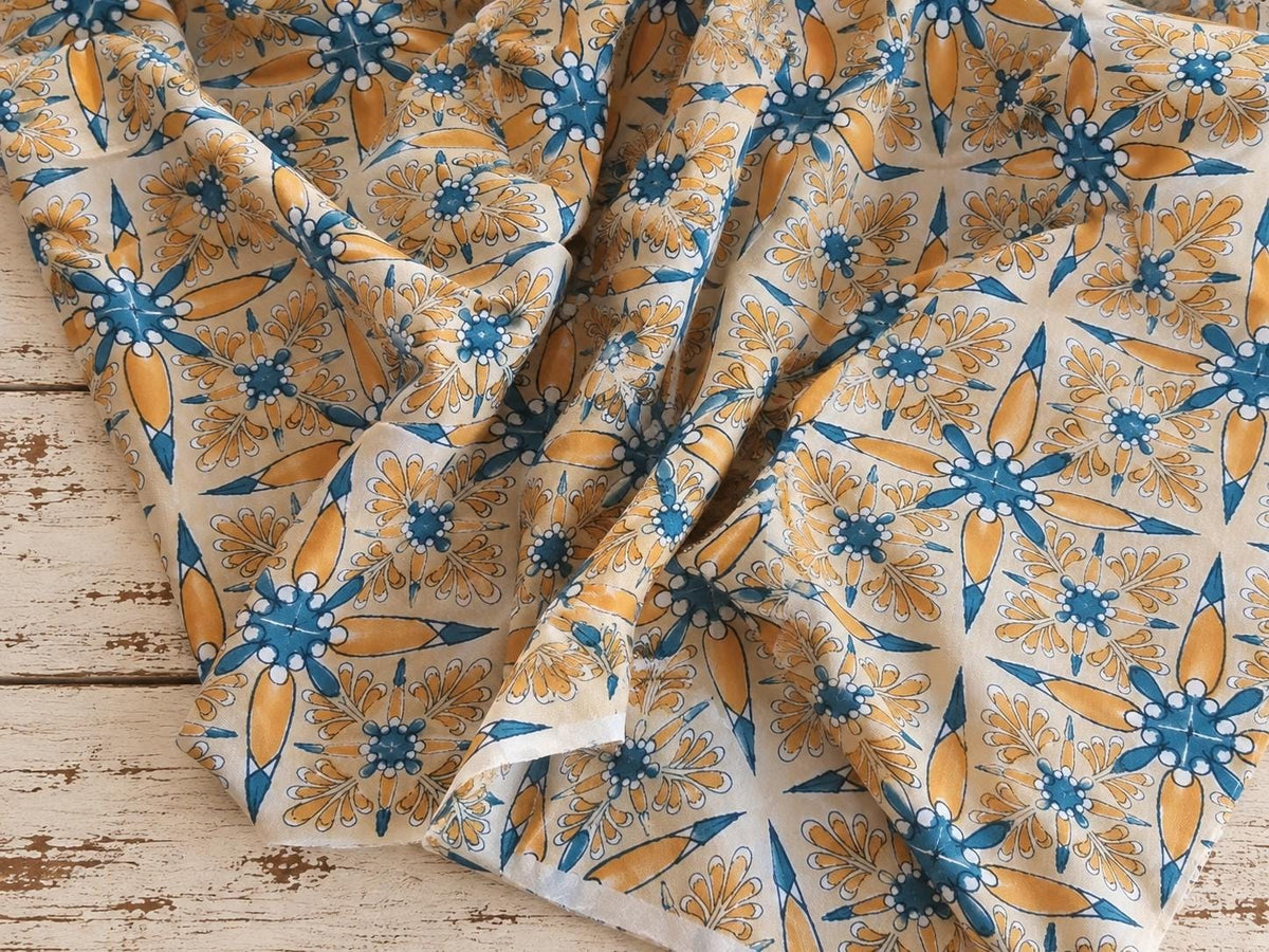 Folk Bloom hand printed cotton fabric shown draped to show its soft texture and pattern