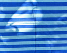 Close-up of the woven texture and contrasting blue bands of Azure Tide fabric.