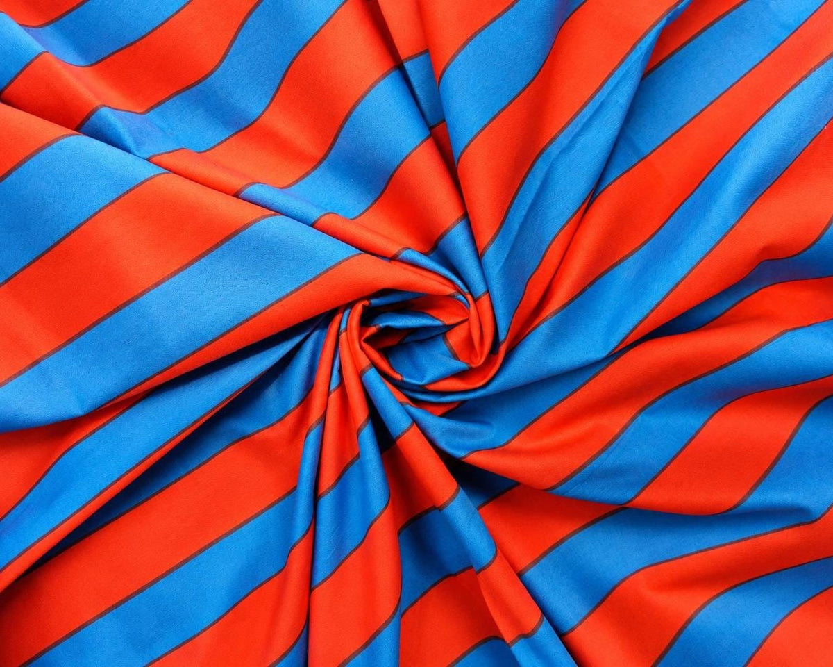 Close view of red and blue stripes on hand screen printed lightweight cotton fabric