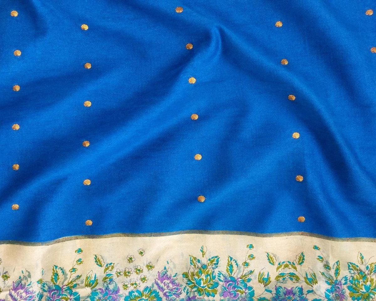 Royal blue pure silk sari fabric with small gold-toned dots and an ivory floral border.