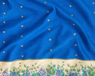 Royal blue pure silk sari fabric with small gold-toned dots and an ivory floral border.