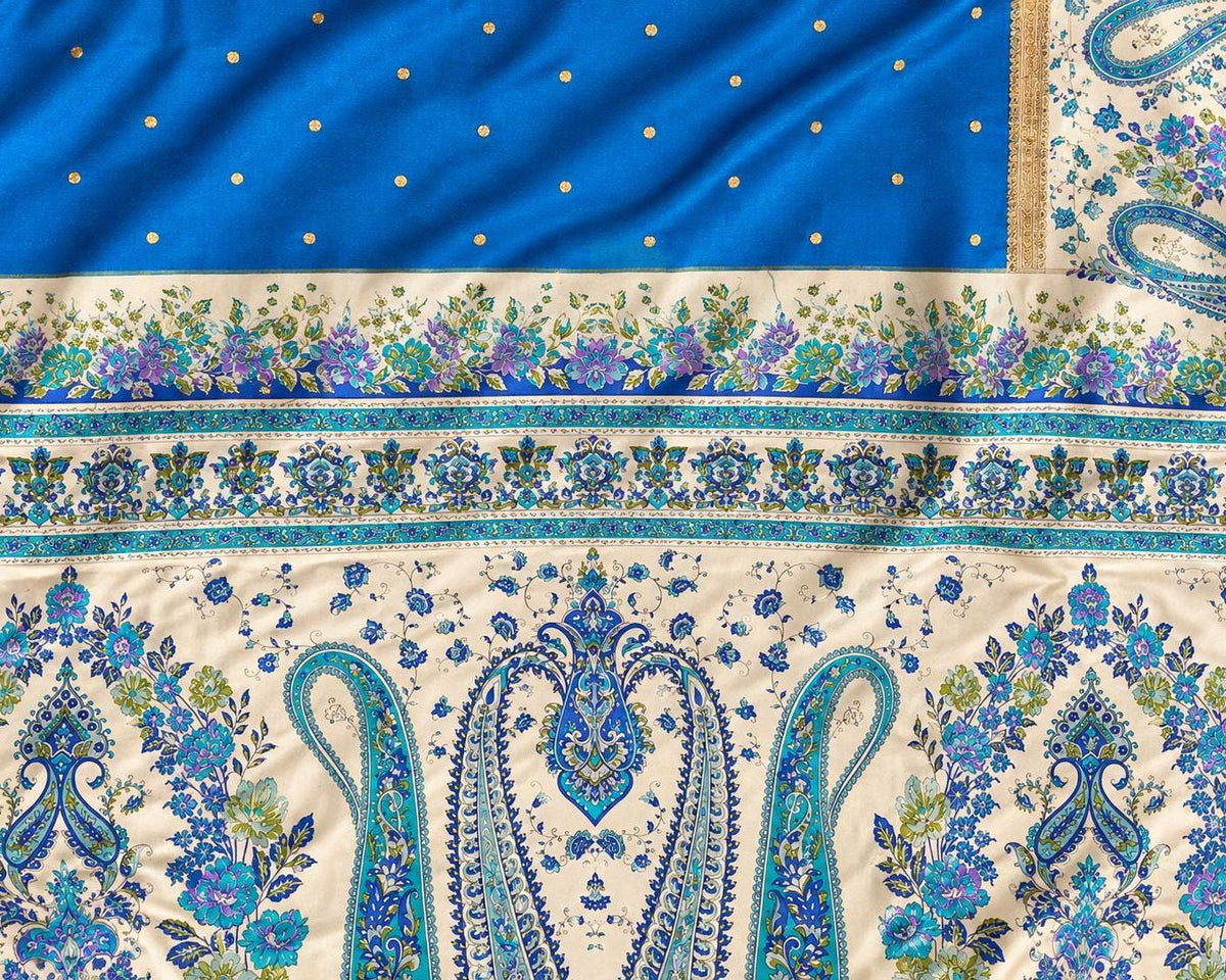 Vintage silk fabric with an ivory ground, ornate turquoise paisley motifs and floral borders.