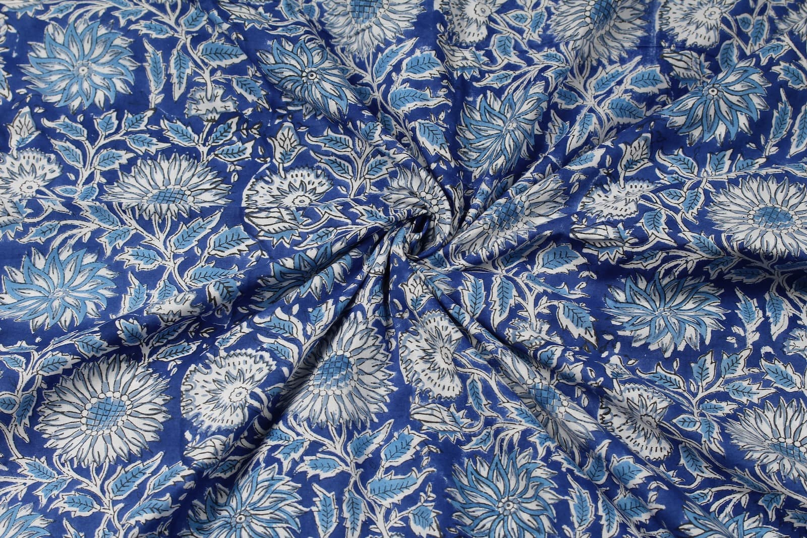 Indigo Chrysanthemum Heritage block print cotton fabric gathered to showcase drape, texture, and floral pattern detail