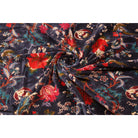 Folded dark blue velvet showing red-orange floral details