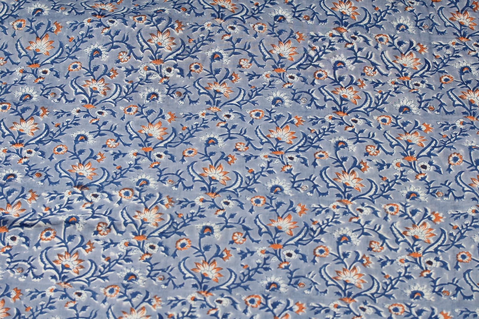 Powder blue floral block print cotton fabric with indigo vines and scattered wildflowers