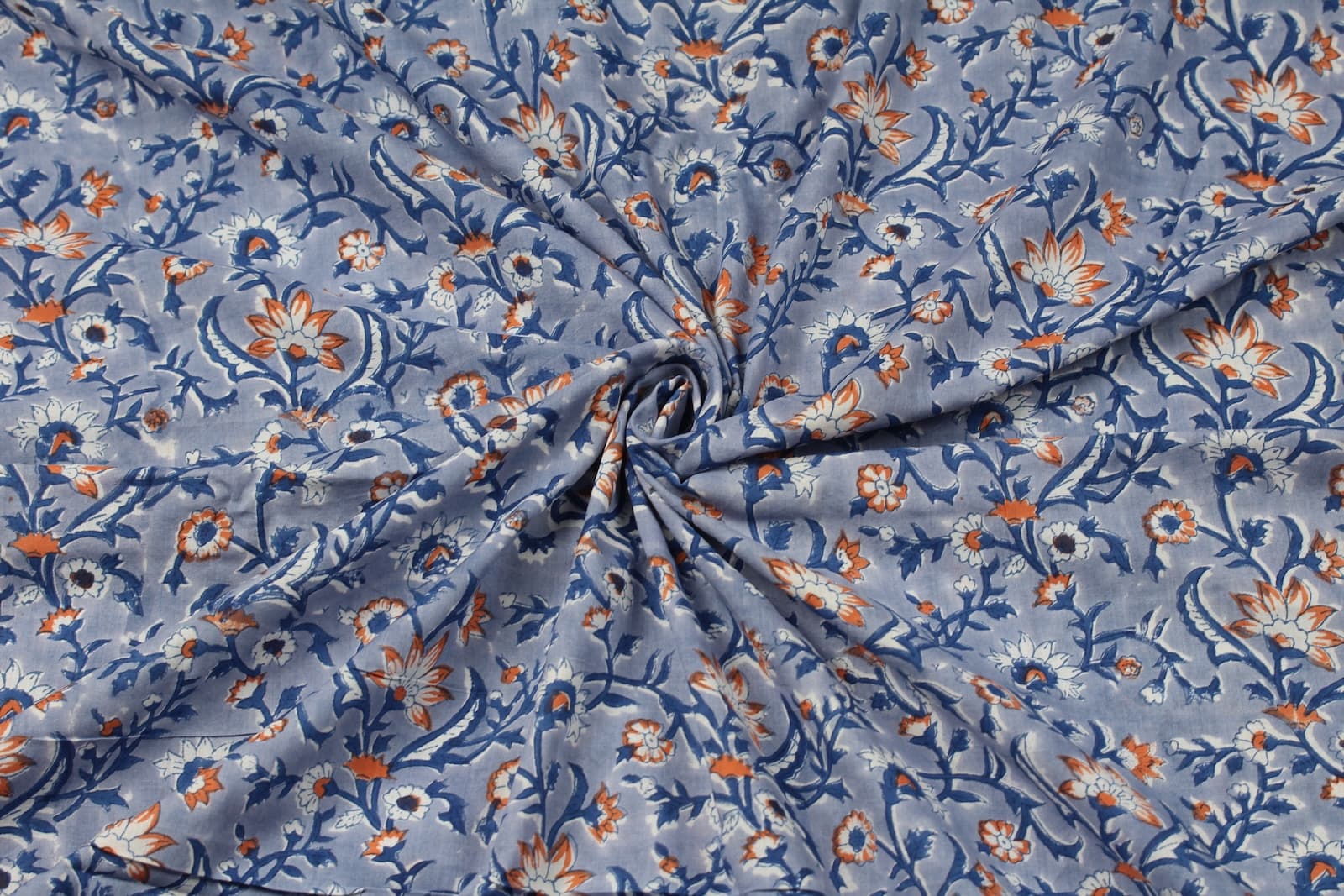 Hand block printed cotton fabric draped to show floral pattern, texture and fabric movement