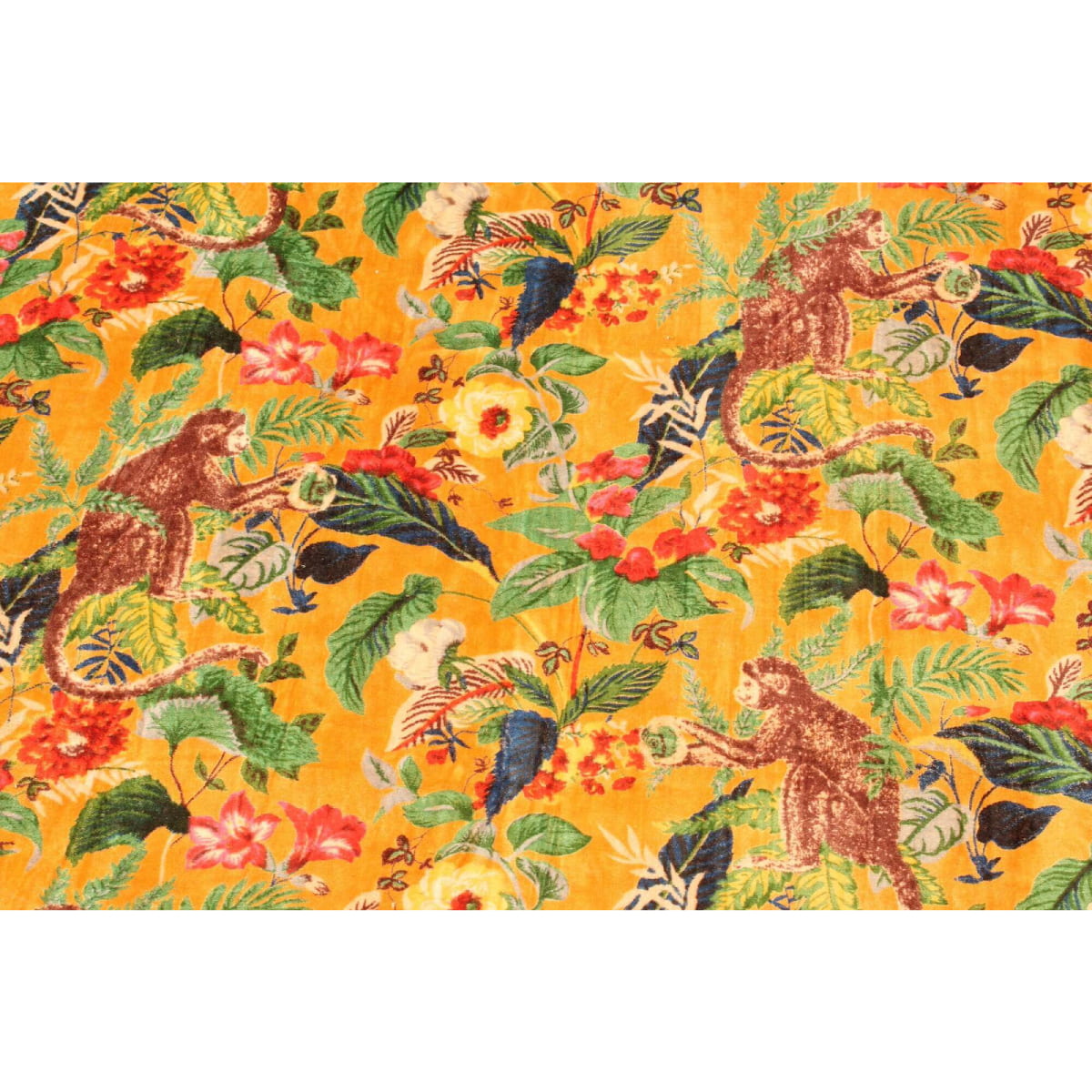 Close-up of monkey and tropical leaves on mustard velvet