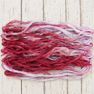 Close up texture of crimson pink and lavender sari silk ribbon yarn