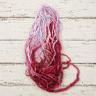 Loose strands of Berry Blossom recycled sari silk ribbon yarn