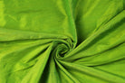 Lime Green Dupion Silk Fabric arranged in elegant swirling folds highlighting its lustrous sheen, crisp texture, and vibrant green colouring