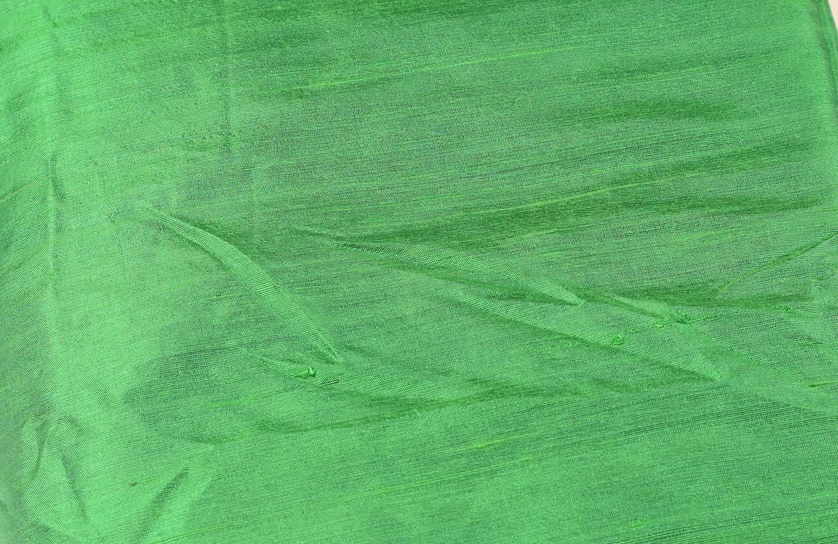 Close-up of Spring Green Dupion Silk Fabric showing natural slub texture, woven silk detail, and fresh vibrant green colour