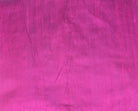 Close-up of Fuchsia Magenta dupion silk fabric showing vibrant pink colour, natural raw silk texture, and characteristic silk slubs
