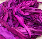 Detailed view of recycled sari silk ribbon in vibrant orchid, magenta and purple shades.