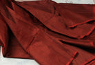 Mahogany Burgundy Dupion Silk Fabric displayed in flowing folds showing its deep burgundy colour and luxurious silk sheen