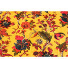Close-up of hand-printed red and orange floral design on yellow velvet