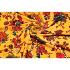 Folded yellow velvet showing rich floral texture and print detail