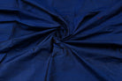 Midnight Blue Dupion Silk Fabric arranged in elegant swirling folds highlighting its lustrous finish and natural dupion silk texture