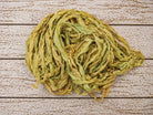 Coiled olive moss chiffon silk ribbon yarn showing soft texture and drape