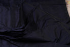 Deep Navy Dupion Silk Fabric displayed in flowing folds showing its rich dark blue tone and lustrous silk finish