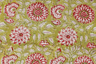 Close-up detail of Olive Blossom block printed cotton fabric showing red and white floral motifs