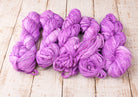 Bundle of orchid sari silk ribbon skeins displaying colour consistency and texture.