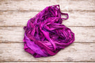 Nest-style arrangement of Wild Orchid sari silk ribbon showing rich colour variation and texture.
