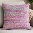 Decorative cushion made from handwoven sari ribbon fabric in pastel pink and lilac tones.