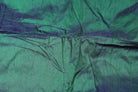 Peacock Lagoon dupion silk fabric draped to display iridescent blue-green sheen, natural slubs, and luxurious raw silk texture