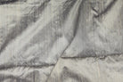 Silver Pewter dupion silk fabric draped to display metallic silver finish, natural slubs, and textured raw silk weave